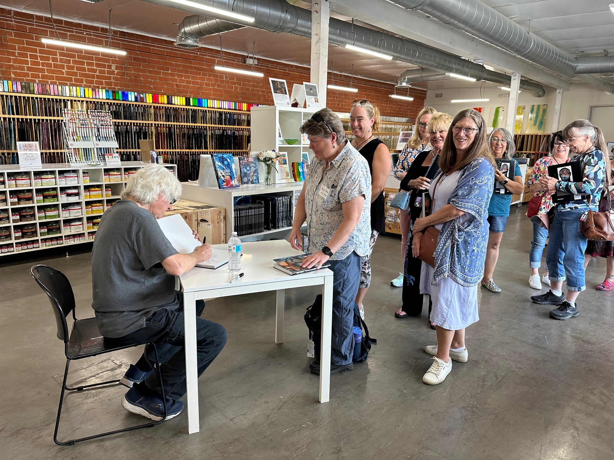 Narcissus Quagliata signing books at Bullseye Glass Los Angeles